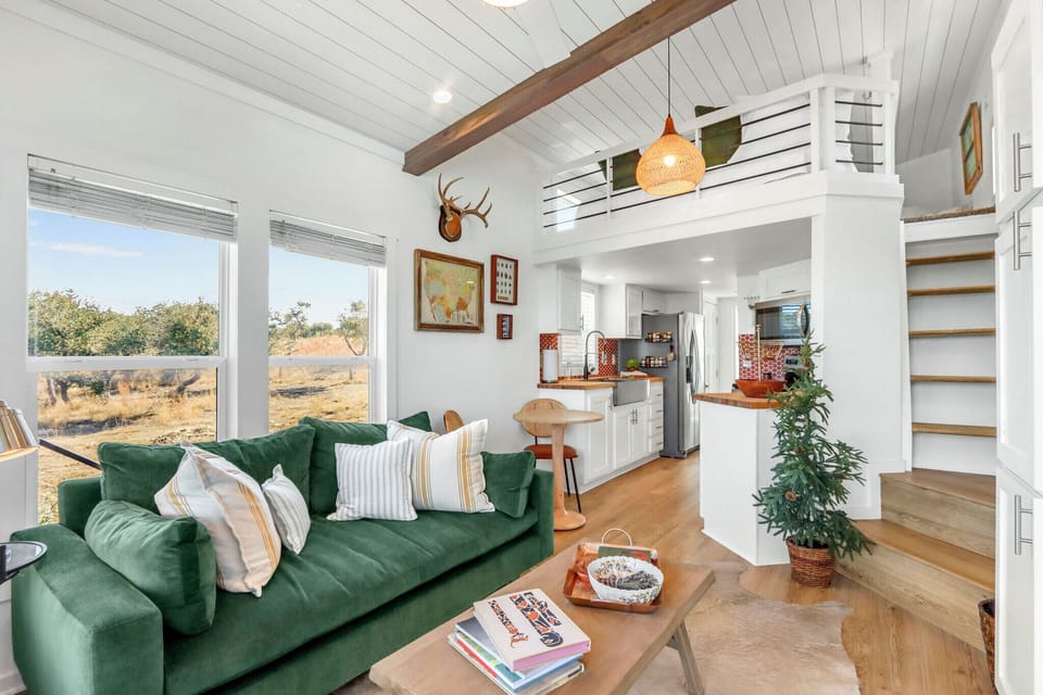 Relax in the bright, open living space featuring expansive windows.