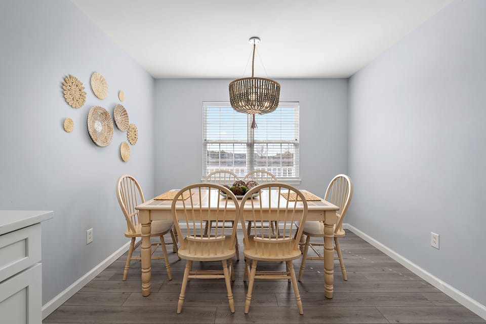 4306 Pettinaro Drive, Bethany Bay - Ocean View - Dining overview - Full perspective of the dining space showcasing the light wood-style flooring and airy, coastal color palette.