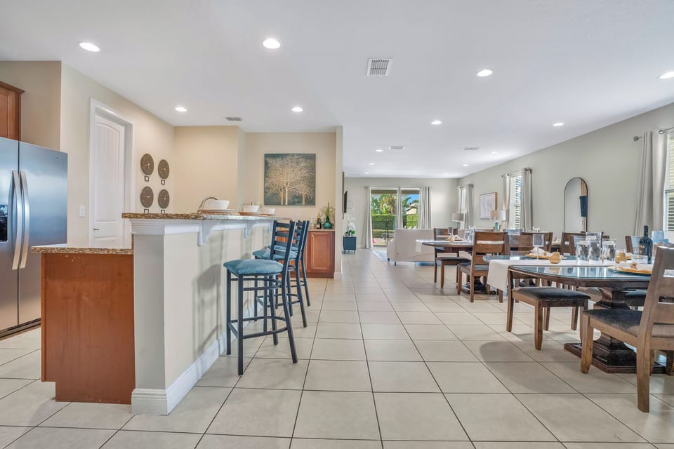 Open-concept layout w/ kitchen bar seating & large dining area