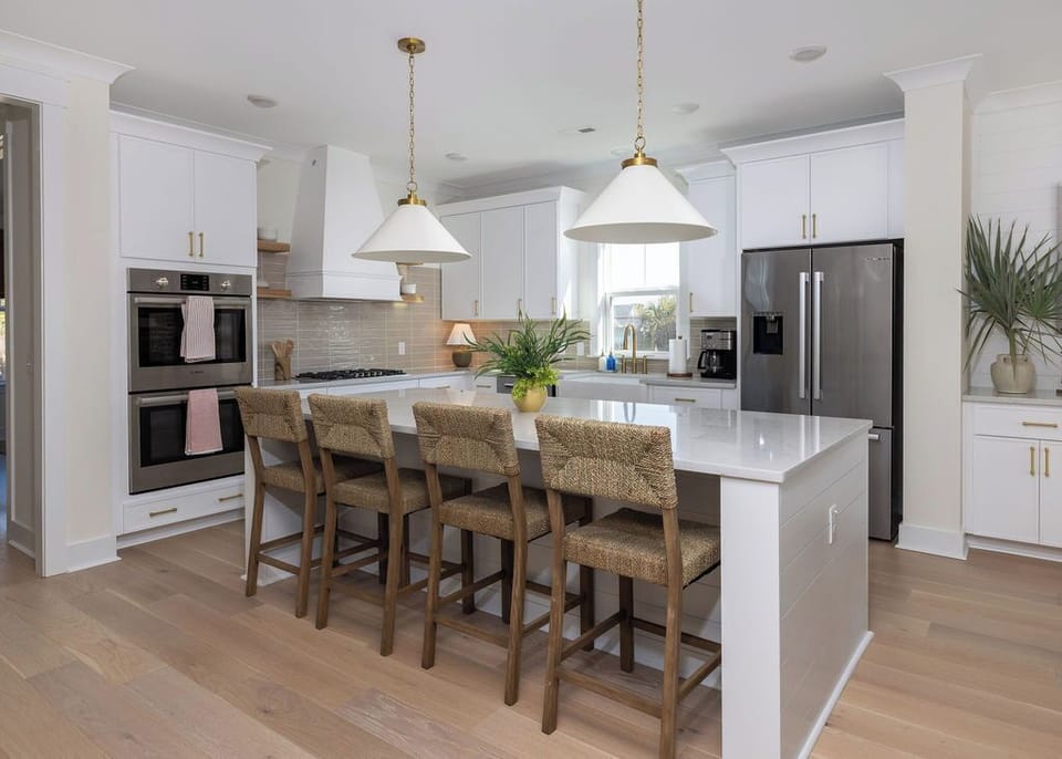 Your dream kitchen awaits with sleek white cabinetry, premium appliances, and a spacious island perfect for morning coffee or evening meals.