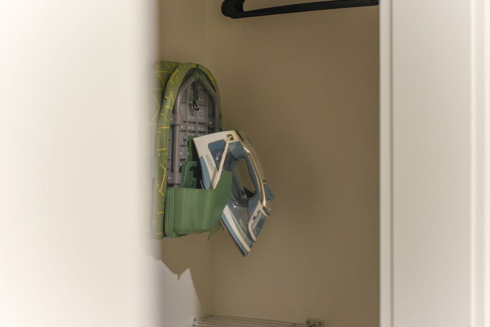Closet with iron and ironing board for a wrinkle-free stay. ✨