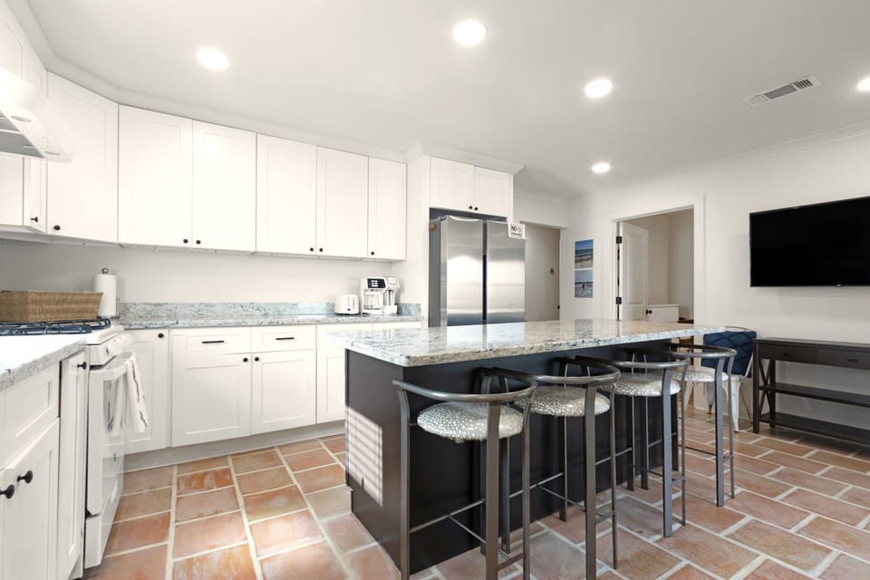 Fully stocked kitchen with extra seating.