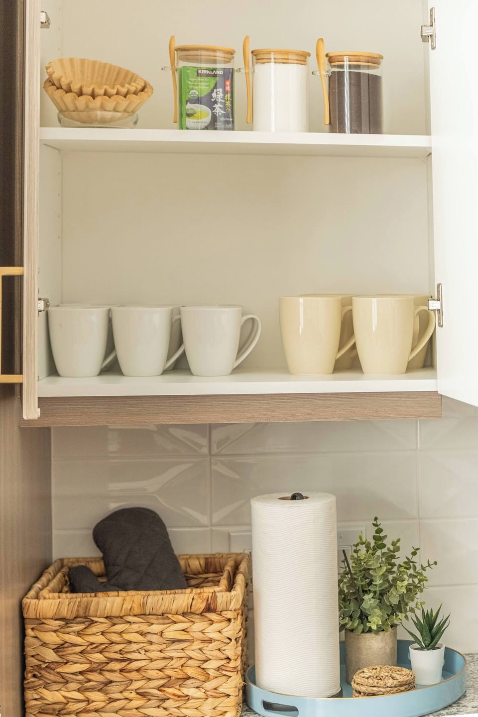 Open kitchen shelving stocked with mugs, cups, and neatly arranged essentials. Designed for quick access and a welcoming feel, making morning coffee or evening tea easy and enjoyable.
