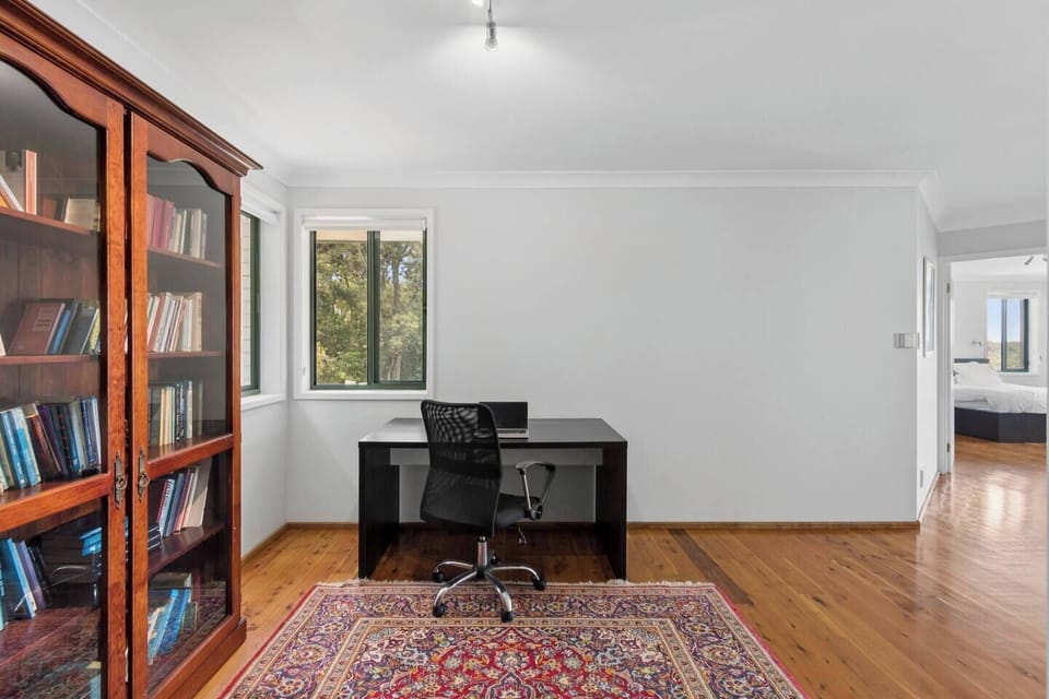 Make use of the dedicated workspace, where full bookshelves, natural light, and a quiet, tucked-away layout create an ideal space for focused work or reading.