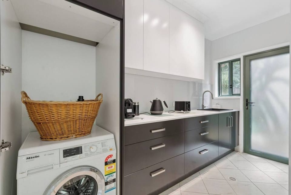 Enjoy the convenience of in-home laundry, with a washer discreetly located in the butler’s pantry to keep daily routines effortless.