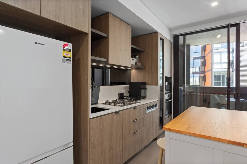 Prepare meals with ease in the streamlined kitchen, where modern appliances and essentials support simple, stress-free cooking.