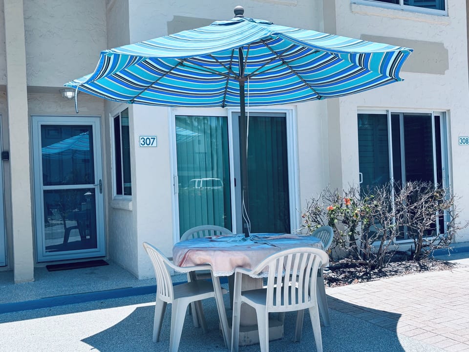 Outdoor patio with shaded seating—perfect for morning coffee or relaxing outside