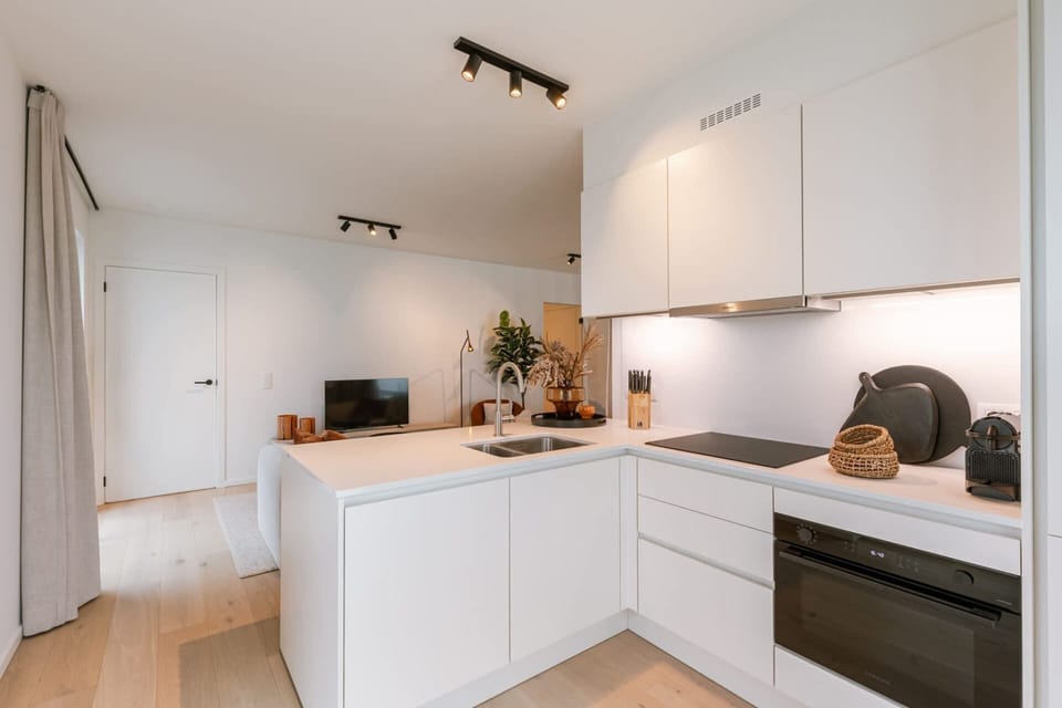 Clean, white, and fully equipped - a kitchen that means business.