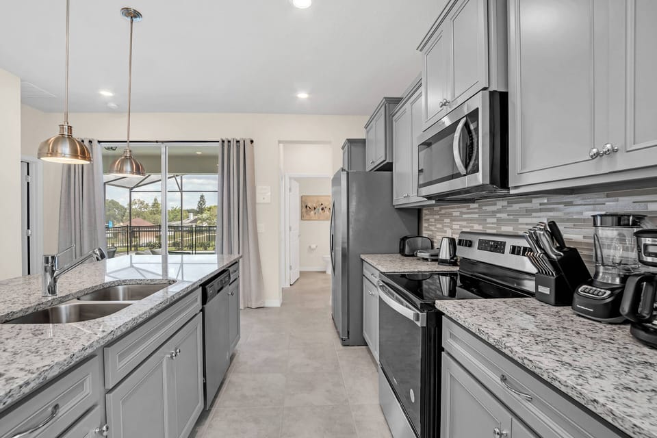 Welcome to this inviting kitchen with sleek gray cabinetry and a beautiful granite countertop, perfect for your culinary creativity.