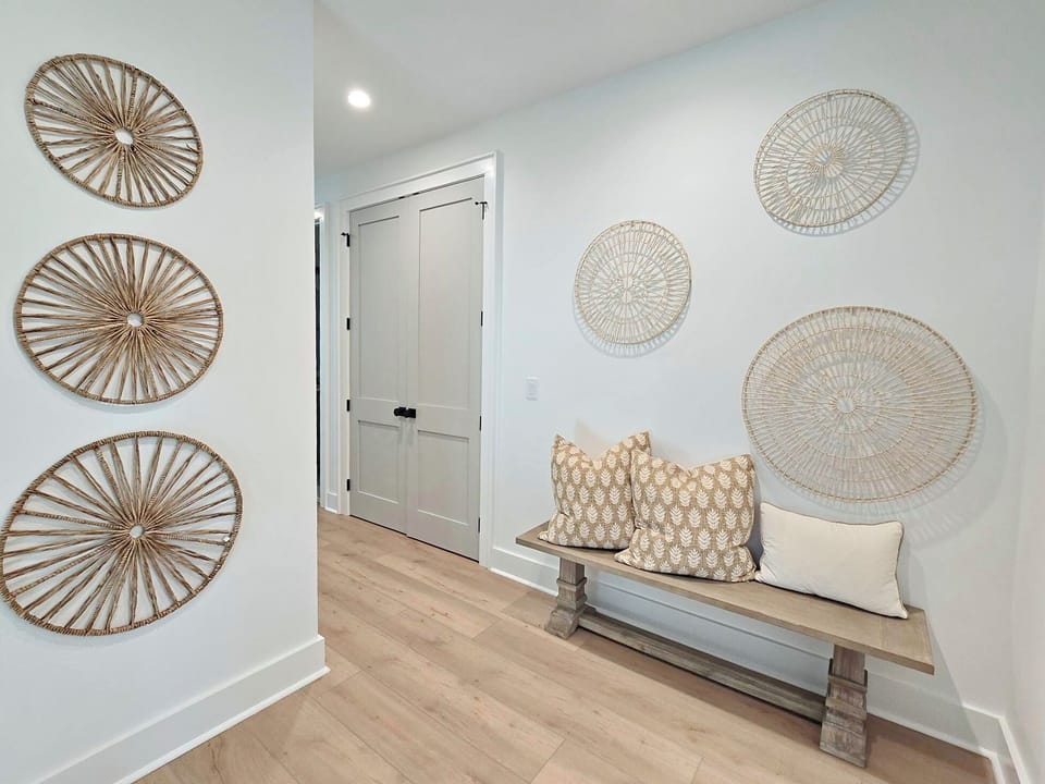 Step into your welcoming entryway where coastal charm meets modern comfort, featuring a stylish bench perfect for settling in.