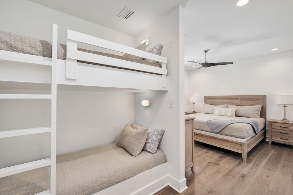 Your family room offers built-in bunk beds perfect for kids, plus a cozy double bed with warm wood tones and soft linens.