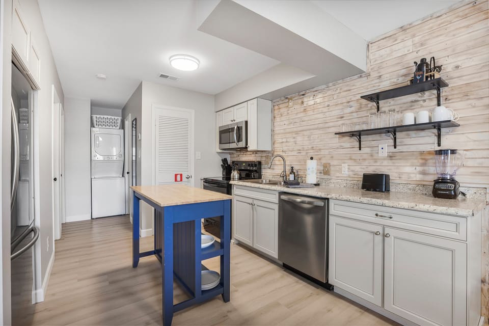 Enjoy a fully equipped kitchen featuring a spacious full-sized refrigerator, perfect for storing all your groceries and beverages. The kitchen also includes modern appliances, ample counter space, and a dining area!