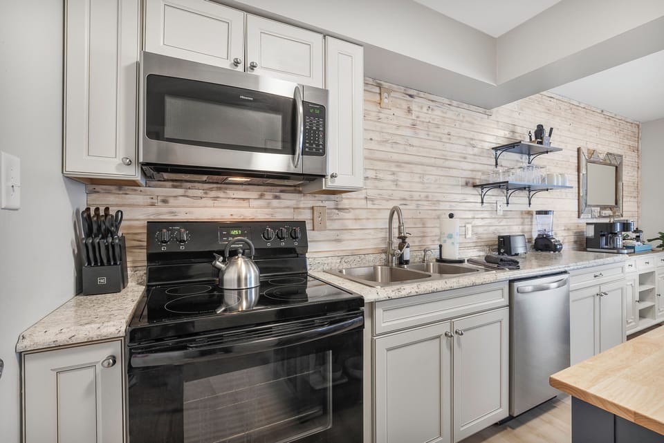 Enjoy a fully equipped kitchen featuring a spacious full-sized refrigerator, perfect for storing all your groceries and beverages. The kitchen also includes modern appliances, ample counter space, and a dining area!