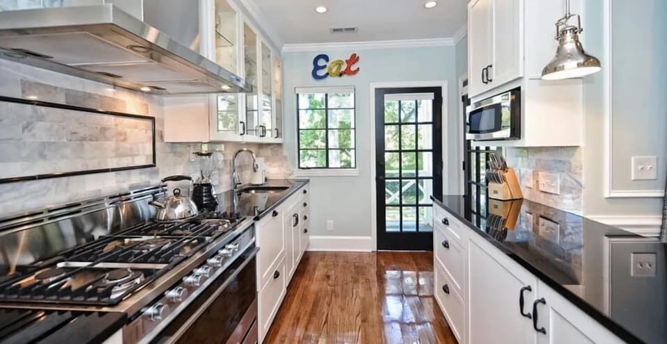 Modern appliances and sleek surfaces make preparing daily meals an absolute joy.
