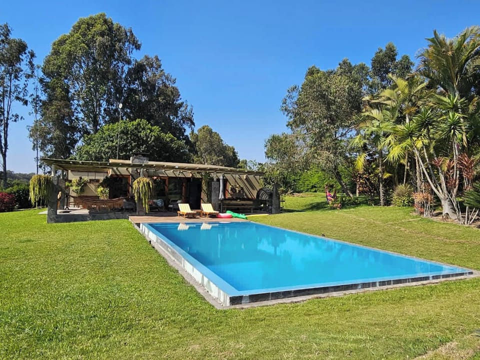Amazing swimming pool surrounded by green areas, perfect for enjoying sunny days outdoors.

