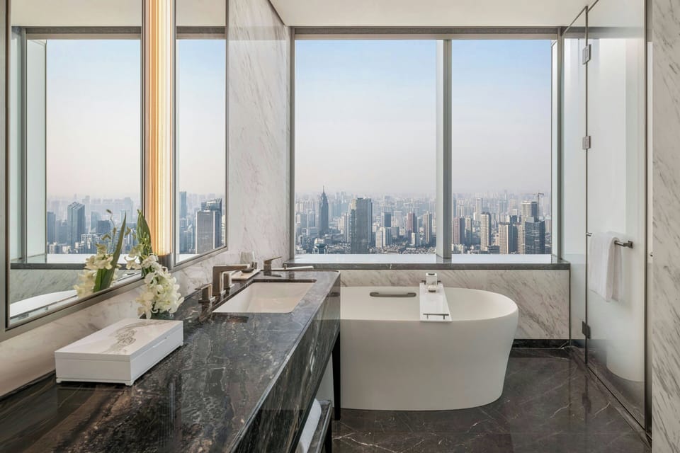 Separate tub and shower, rainfall showerhead, designer toiletries