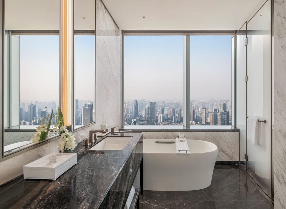 Club City Skyline Suite | Bathroom | Separate tub and shower, rainfall showerhead, designer toiletries
