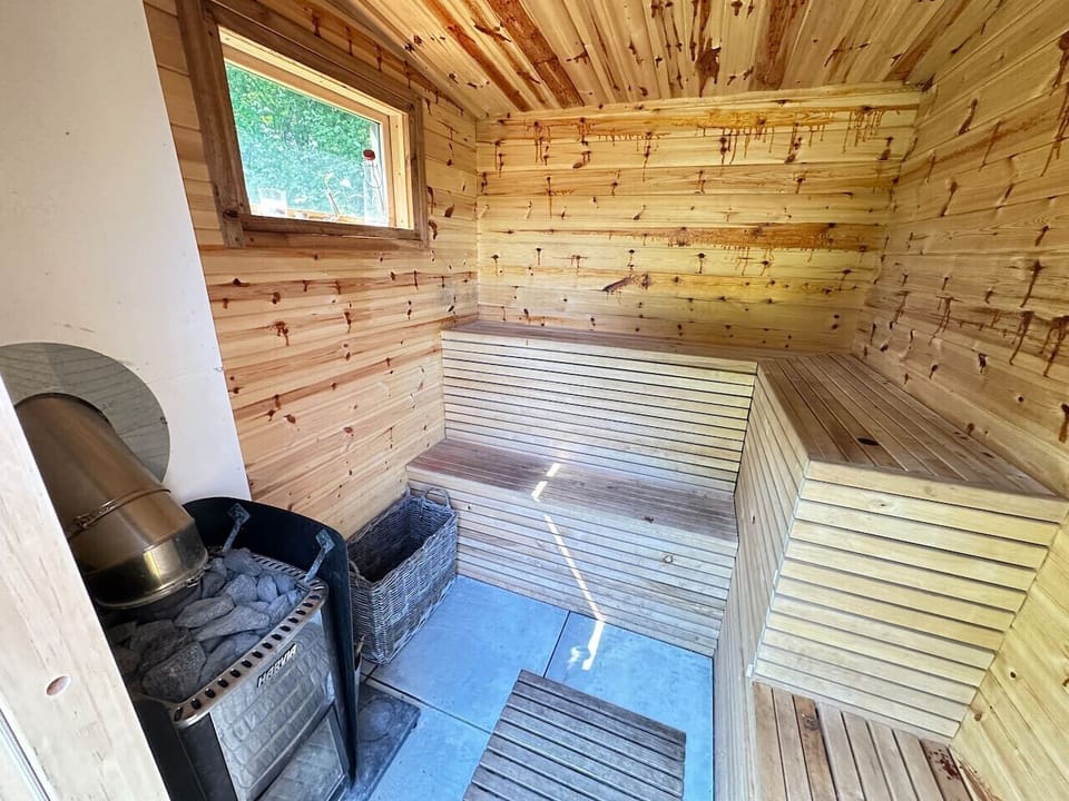 Unwind in the shared wood-fired sauna after a long walk.