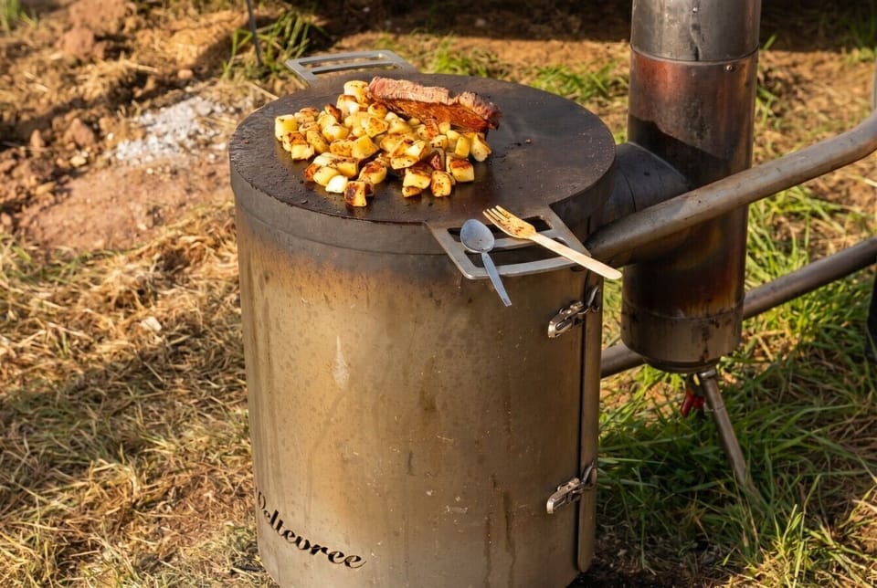 Sizzle steak and potatoes on the wood-fired flat-top stove.