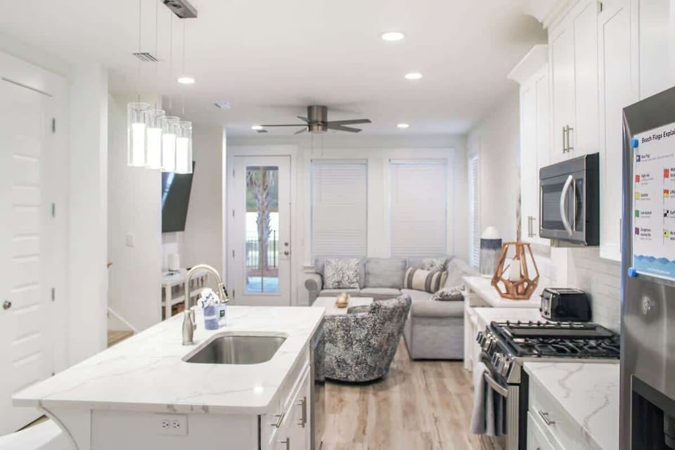 Bright open-concept layout connecting living, dining, and kitchen