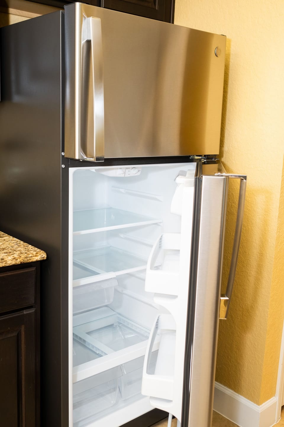 Spacious stainless steel refrigerator with ample storage and organized shelves.