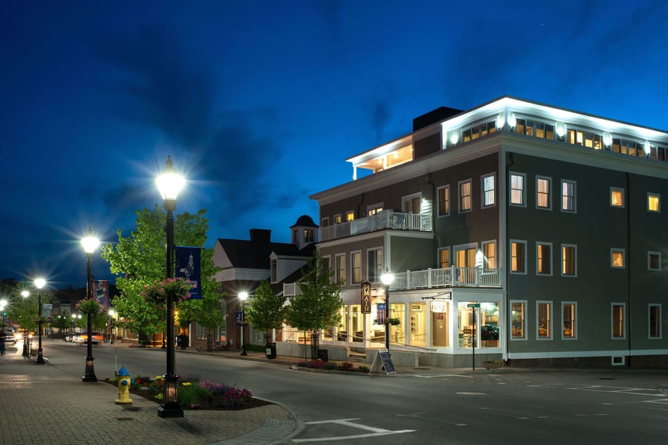 As twilight casts a gentle glow over the charming streets of Kennebunk, this resort stands elegantly illuminated, inviting guests to experience its upscale coastal charm.