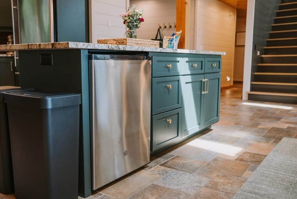 The Main Cabin
The kitchen island is packed with thoughtful extras just for you! You'll find a beverage fridge, a drawer with coloring supplies for little ones (on the left), a neatly organized junk drawer, and plenty of extra storage throughout.