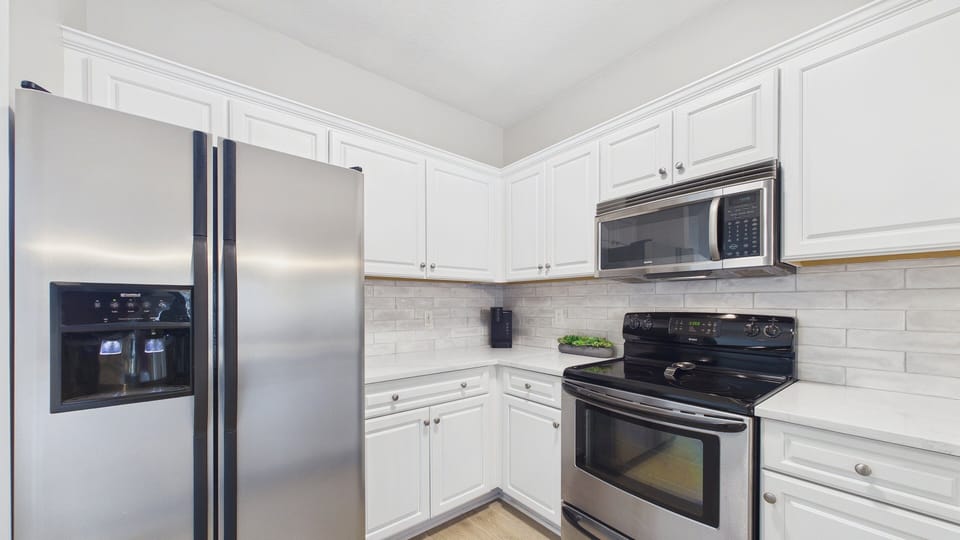 Full fridge along with coffee essentials in kitchen area