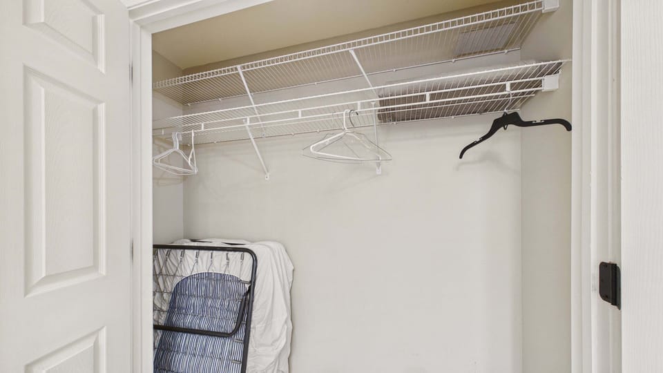 Guest bedroom closet with twin rollaway bed (sleeps 1)