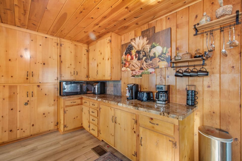 Kitchen with Keurig coffee maker and ample cabinet storage.