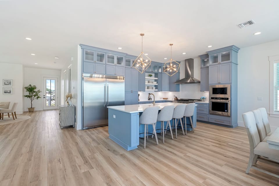 Second-floor open concept living area features the large luxury kitchen.