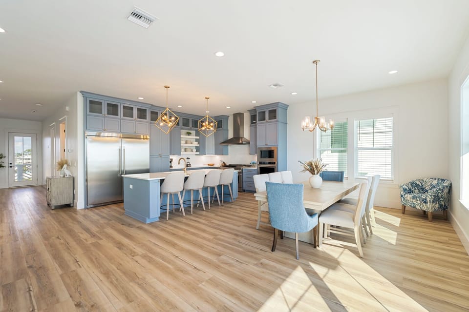 Second-floor open concept living area with large dining area right next to the luxury kitchen.