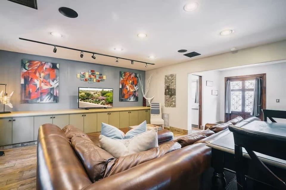 Bright and open living area featuring cozy furnishings and a Smart TV.