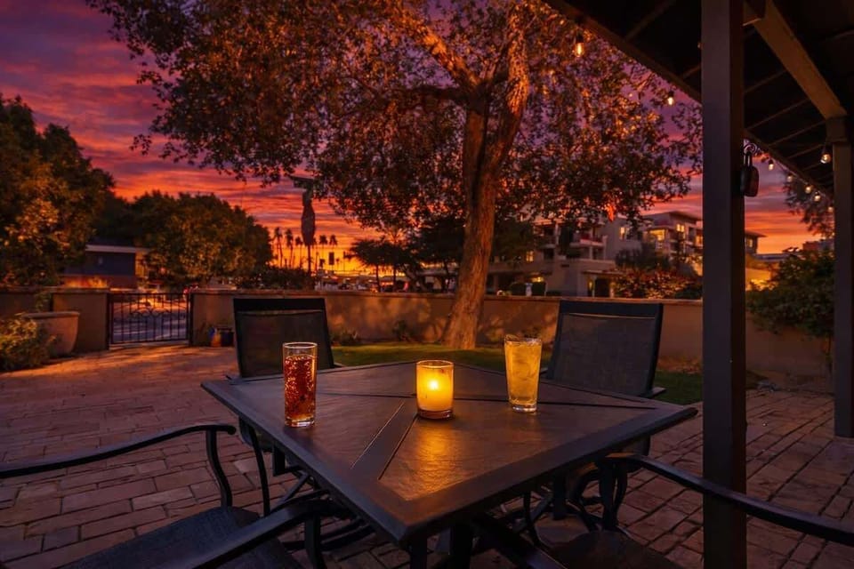 Shared front yard with multiple outdoor dining areas.