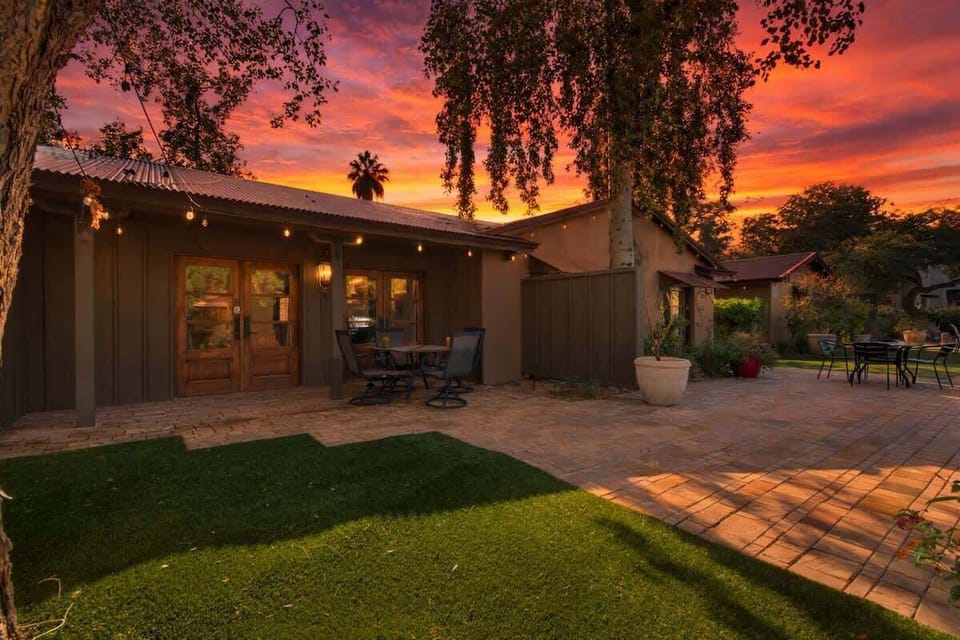 Shared front yard with multiple outdoor dining areas.