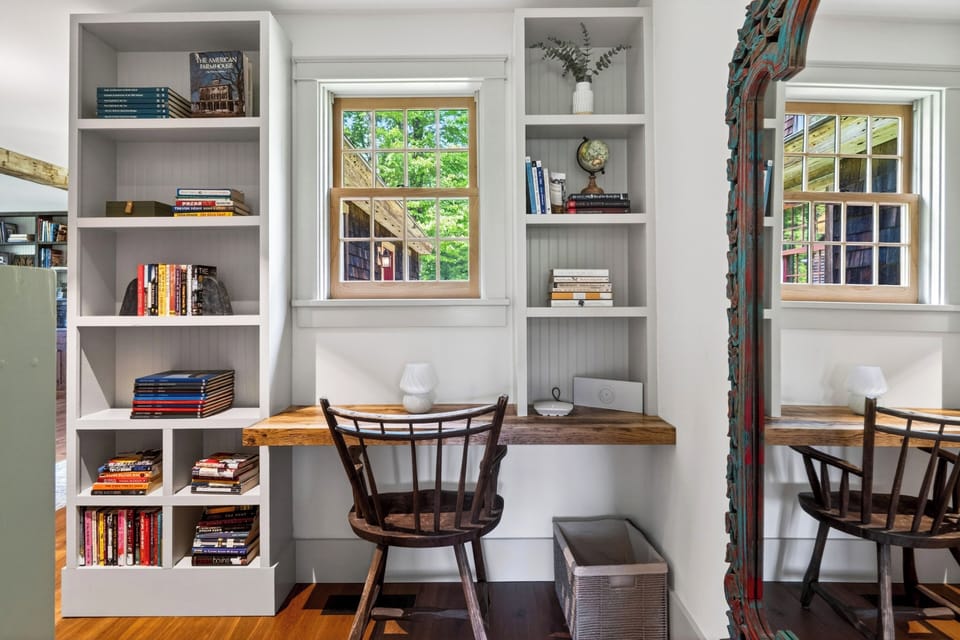 Cozy reading nook with built-in shelves, a dedicated desk, and peaceful natural light.