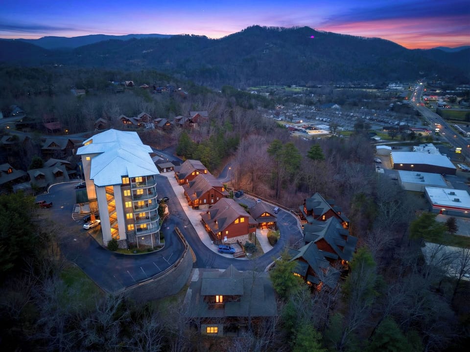 Aerial twilight view of the cabin resort nestled in the mountains.