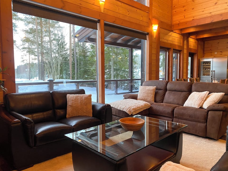 Deluxe Villa, Lake View | Living room | 65-inch Smart TV with cable channels, fireplace, heated floors