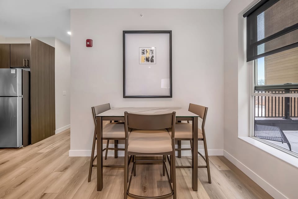 Gather around your stylish dining table for meals and conversations, with natural light streaming through the window.