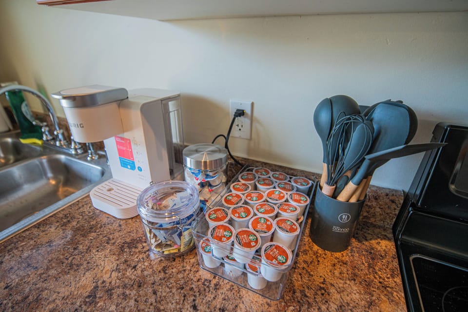 Your mornings start perfectly with a well-stocked coffee station featuring premium K-cups and all the brewing essentials you need.