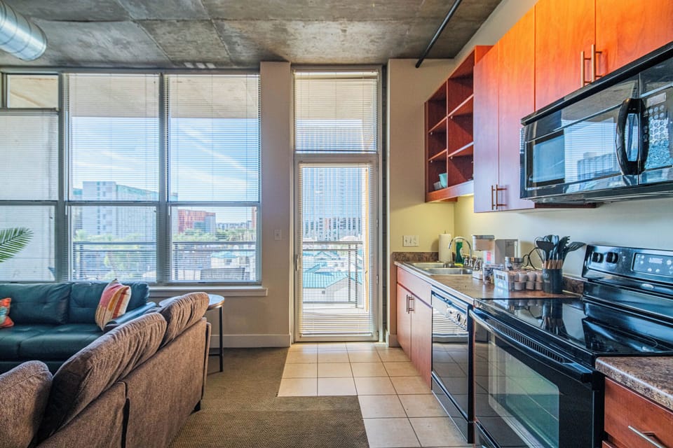 Cook with city views in your modern kitchen, then relax on the sofa while enjoying panoramic skyline vistas through floor-to-ceiling windows.