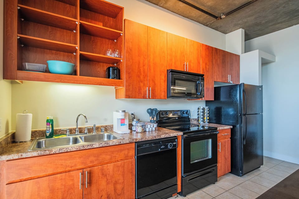 Your fully equipped kitchen features rich wood cabinetry, granite countertops, and modern appliances for effortless home-cooked meals during your stay.