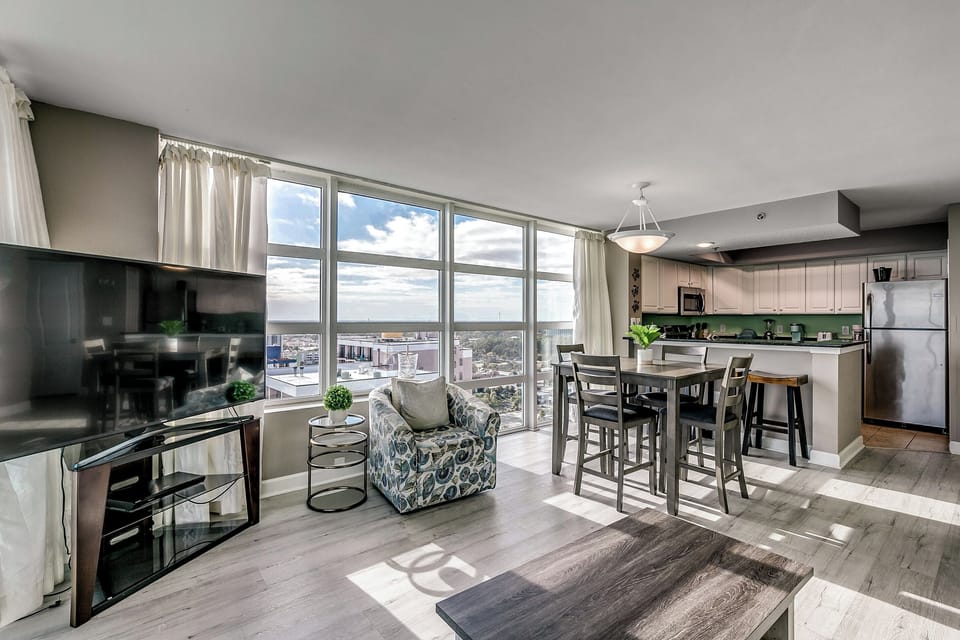 Large living area with flat screen TV and dining table.