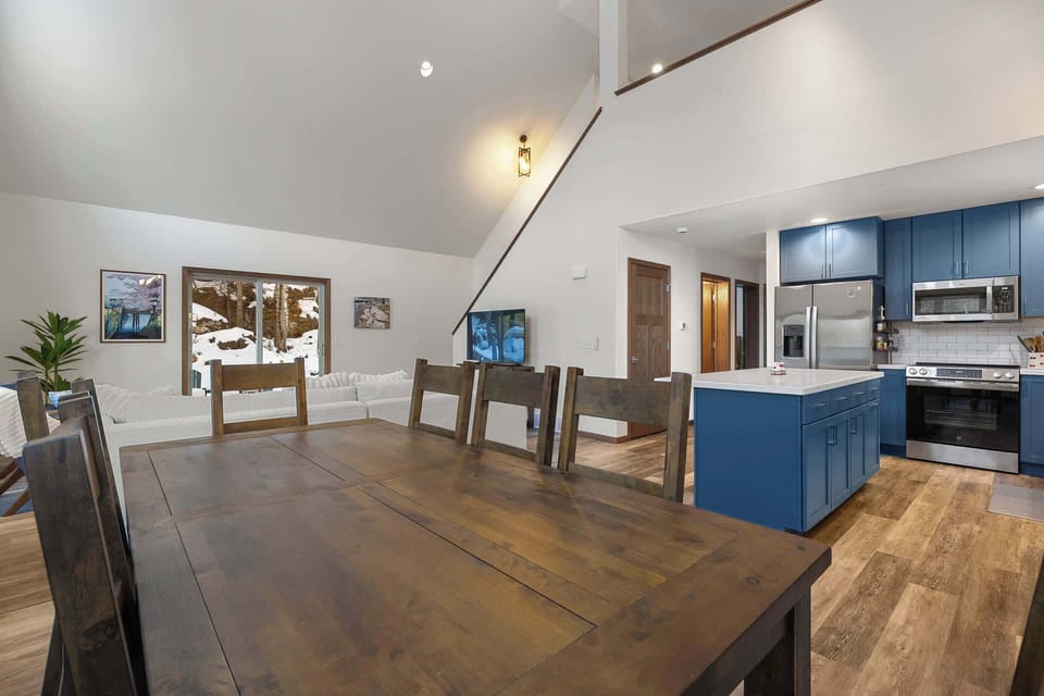 Gather around this spacious dining table where shared meals become cherished memories, while the modern kitchen awaits your culinary adventures.