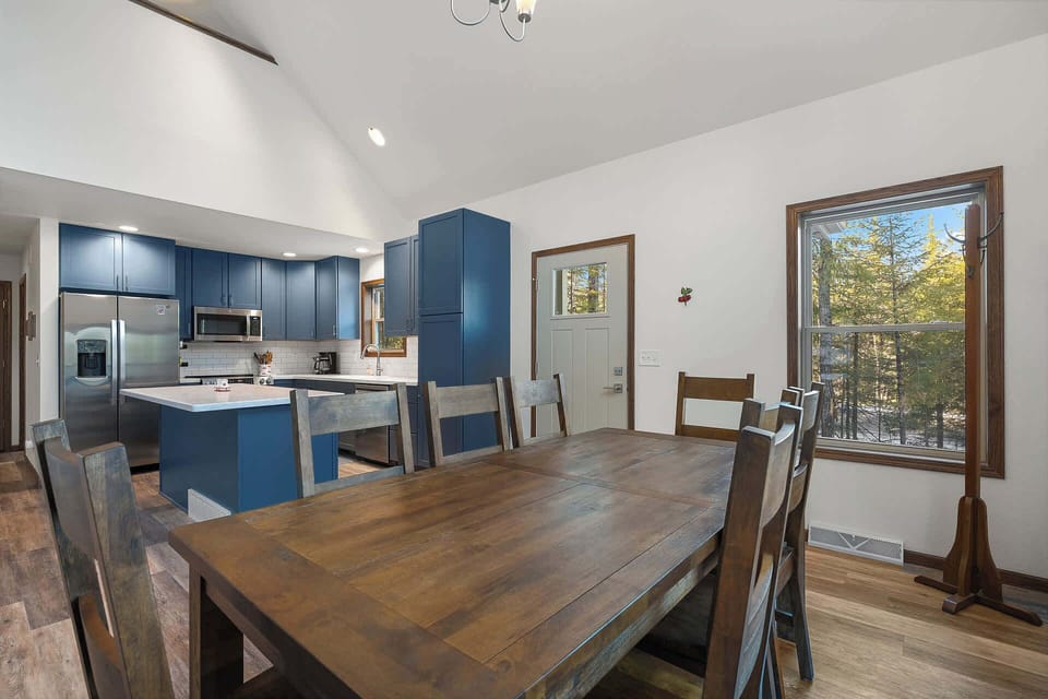 Gather around this rustic dining table where your group can share meals while enjoying forest views through the window.