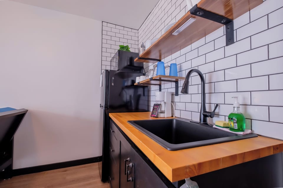 Your stylish kitchen features warm wood countertops, modern subway tile backsplash, and everything you need to create delicious meals during your stay.