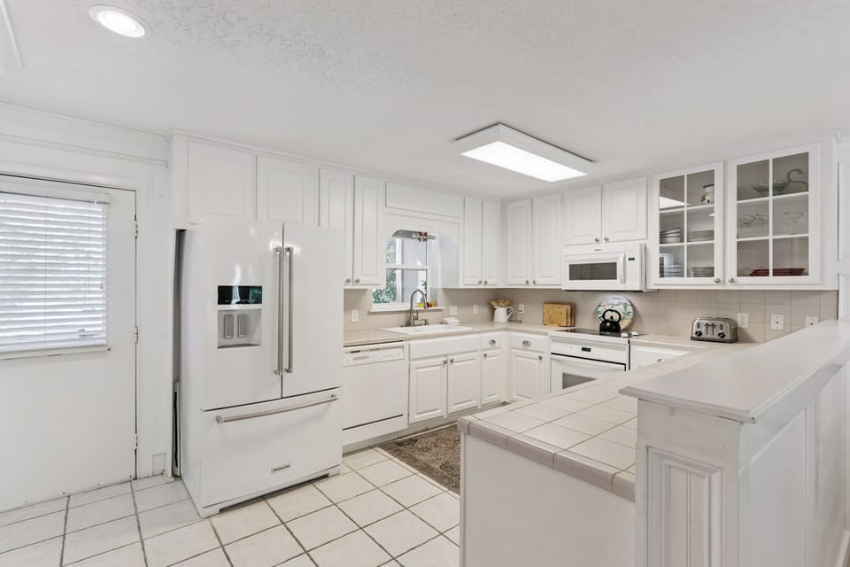 Your bright, fully-equipped kitchen awaits with modern appliances, ample counter space, and everything needed for memorable meals.