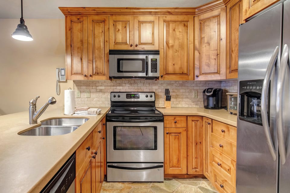 Your fully equipped kitchen features warm wood cabinets and stainless steel appliances.