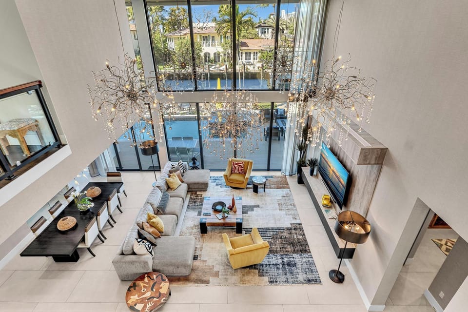 Spacious luxury living room with upscale décor, generous seating, and large Smart TV — ideal for group stays and elevated entertaining.