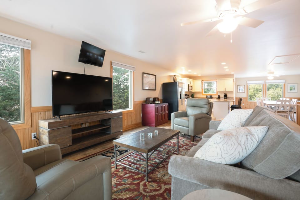 Unwind in your spacious living room with plush seating, modern entertainment center, and warm wood accents creating the perfect retreat.